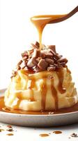 Creamy dessert topped with crunchy toffee pieces and rich caramel sauce in a simple presentation photo