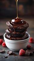 Decadent chocolate cookies with warm sauce and fresh raspberries on a dark background photo
