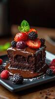 Decadent chocolate cake topped with fresh berries served on a black plate in a cozy setting photo
