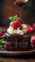 Chocolate dessert topped with cream and fresh raspberries on a wooden table photo