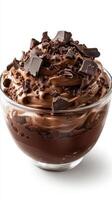Decadent chocolate dessert in a glass bowl topped with chocolate shavings and chunks photo