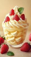 Delicious dessert featuring whipped cream, bananas, and fresh strawberries in a clear cup photo