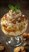 Delicious layered dessert with bananas, whipped cream, and crunchy toppings served in a glass bowl photo
