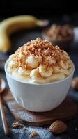 Delicious banana dessert topped with crushed cookies arranged on a wooden board photo