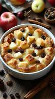Delicious apple cinnamon bread pudding with raisins presented on a rustic wooden table in a cozy kitchen setting photo