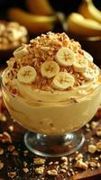 Delicious banana pudding topped with crushed nuts and sliced bananas served in a glass bowl photo