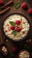 Delicious bowl of creamy oatmeal topped with fresh raspberries, almonds, and mint on a rustic wooden table photo