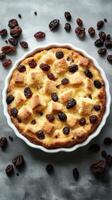 Delicious bread pudding with raisins baked to golden perfection on a grey countertop photo