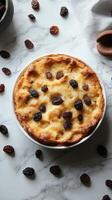 Delicious homemade bread pudding with raisins on a marble countertop photo