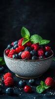 Fresh mixed berries with vibrant colors served in a rustic bowl on a dark background photo