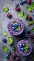 Vibrant chia seed pudding topped with fresh blueberries and raspberries on a dark background photo