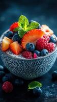 Fresh fruits and yogurt in a textured bowl with vibrant colors and mint leaves on a dark background photo