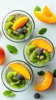 Fresh and vibrant chia seed pudding topped with kiwi, peach, and mint on a light background photo