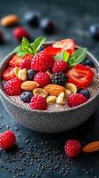 Healthy bowl of chia seed pudding topped with fresh berries and nuts for a nutritious breakfast or snack photo