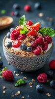 Fresh yogurt bowl topped with assorted berries and granola served in a rustic bowl on a dark textured surface photo