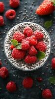 Fresh raspberry parfait with chia seeds and mint on a dark textured background photo
