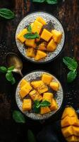 Chia pudding topped with fresh mango and mint served in elegant bowls on a wooden table photo