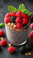 Delicious chia pudding topped with fresh berries and granola sits on a dark surface inviting a healthy treat photo