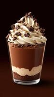 Decadent chocolate dessert displayed in a clear glass with whipped cream and chocolate shavings on top, perfect for sweet lovers photo