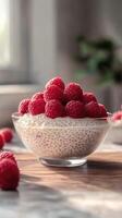 Fresh raspberry chia pudding topped with ripe berries in a sunlit kitchen setting photo