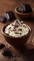 Decadent hot chocolate topped with whipped cream and chocolate shavings on a rustic wooden table photo