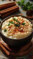 Delicious bowl of creamy rice pudding topped with cinnamon and herbs on a rustic table photo