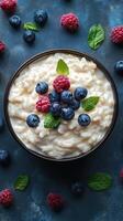 Creamy rice pudding topped with fresh blueberries and raspberries on a vibrant blue background photo