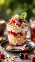 Delicious layered dessert with berries, cream, and nuts served during a sunny afternoon photo