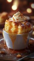Decadent dessert featuring warm, gooey caramel bread pudding topped with whipped cream in an inviting setting photo