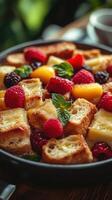 Colorful fruit-topped bread pudding served in a rustic bowl at a cozy cafe in the afternoon photo