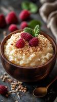 Delicious bowl of creamy rice pudding topped with fresh raspberries and oats, perfect for a healthy dessert photo