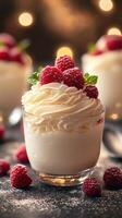 Dessert featuring creamy whipped cream topped with fresh raspberries and mint arranged elegantly on a dark table photo