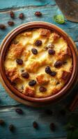 Delicious bread pudding with raisins served in a rustic bowl on a wooden table photo
