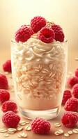 Delightful dessert featuring creamy oats topped with fresh raspberries and whipped cream on a soft golden background photo