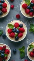 Delicious dessert bowls with fresh berries and mint arranged on a textured surface photo
