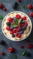 Delicious berry dessert topped with fresh fruits and mint leaves on a dark background photo