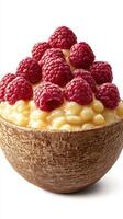 Sweet dessert featuring creamy rice pudding topped with fresh raspberries in a rustic bowl at a cozy table photo
