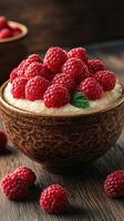 Creamy dessert topped with fresh raspberries in a rustic bowl on a wooden table photo