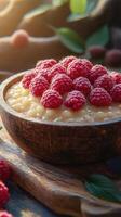 Delicious dessert bowl filled with creamy pudding and fresh raspberries in a warm kitchen setting photo