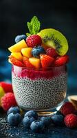 Chia seed pudding topped with fresh fruits in a decorative glass bowl garnished with mint at a stylish setting photo