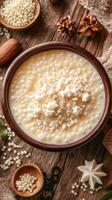 Delicious bowl of creamy tapioca pudding topped with coconut on a rustic wooden table with nuts and spices photo