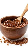 Brown pearls of tapioca served in a wooden bowl with a spoon for dessert preparation and cooking at home photo