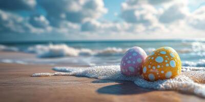 Colorful eggs resting on sandy beach shore with gentle waves under a bright sky photo