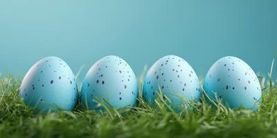 Colorful blue decorated eggs positioned in vibrant grass for a festive spring celebration photo