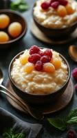 Delicious bowl of creamy rice pudding topped with fresh raspberries and golden fruit on a rustic table photo
