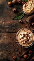 Delicious dessert featuring cream and chocolate garnished with nuts on a rustic wooden table photo
