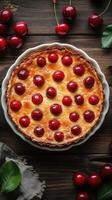 Homemade cherry tart with a golden crust surrounded by fresh cherries on a wooden table photo