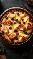 Delicious bread pudding with raisins served in a rustic dish on dark wooden background photo