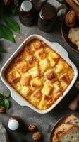Delicious bread pudding topped with a golden crust served in a rustic kitchen setting photo