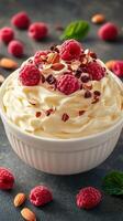 Creamy dessert topped with fresh raspberries and almonds in a white bowl on a textured surface photo